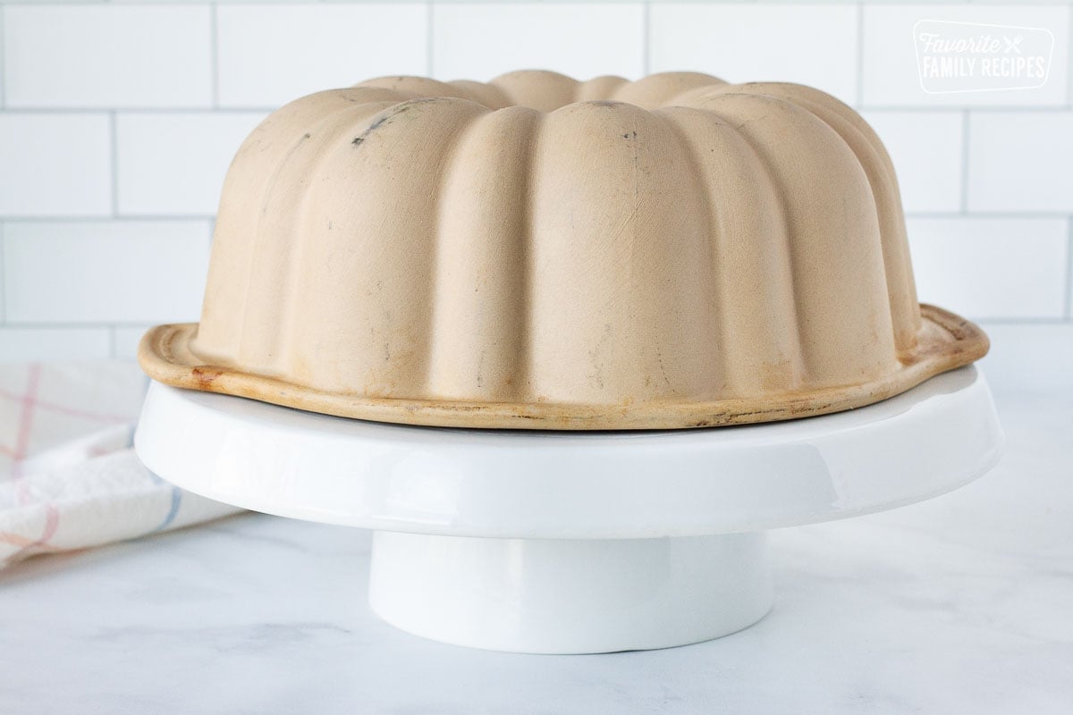 Cake stand with Carrot Bundt Cake pan on top.