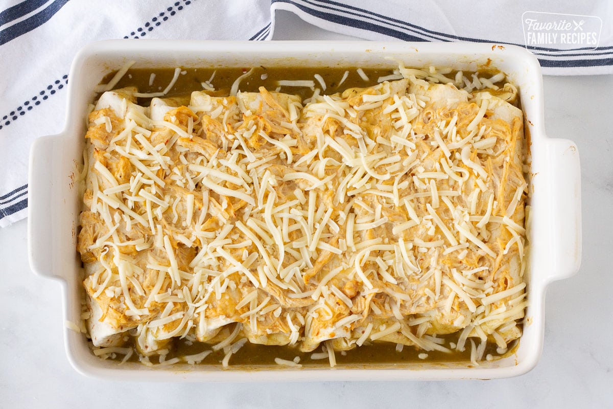 Cheese on top of baked Sour Cream Chicken Enchiladas.