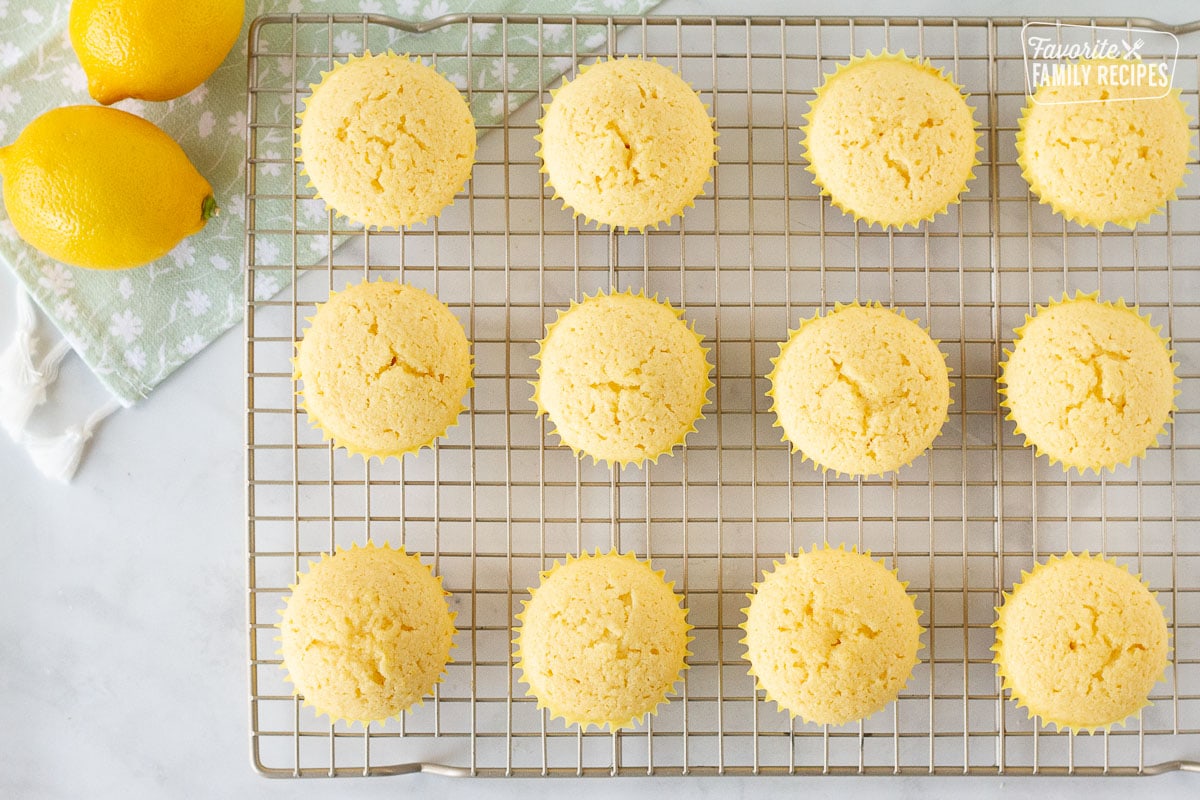 Baked Lemon Cupcakes on a cooking rack.