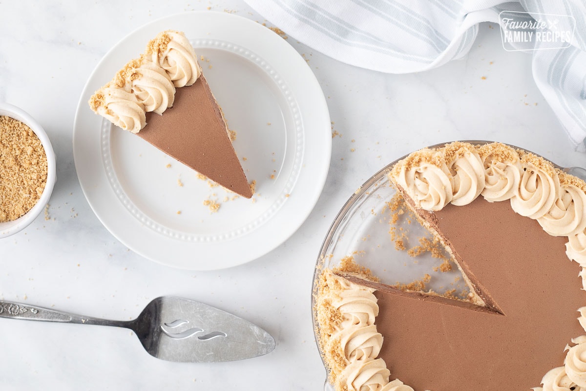 Costco Peanut Butter Chocolate Cream Pie missing a slice with a piece of pie on the side.