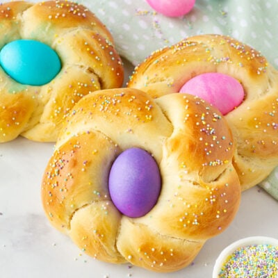 Three loaves of Easter Bread with colored eggs.