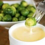 Brussel Sprout being dipped into Cheese Sauce