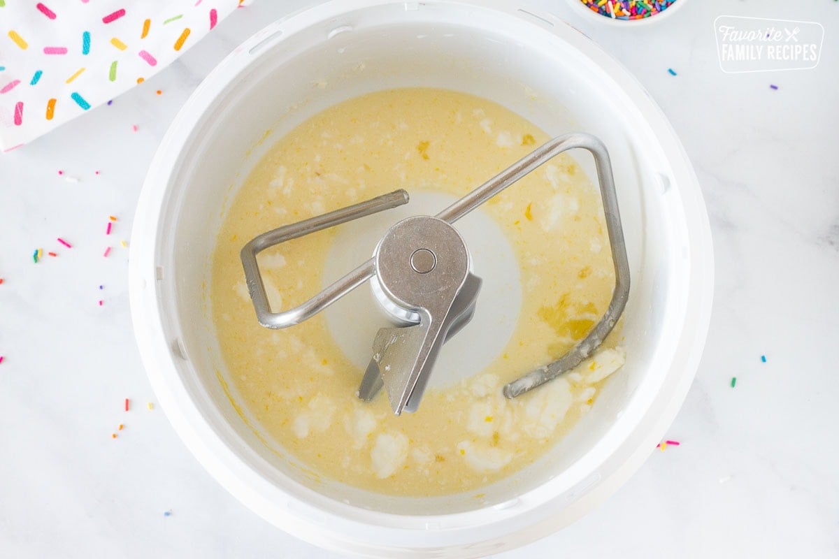 Stand mixing bowl with egg, milk and shortening to make Homemade Donut dough.