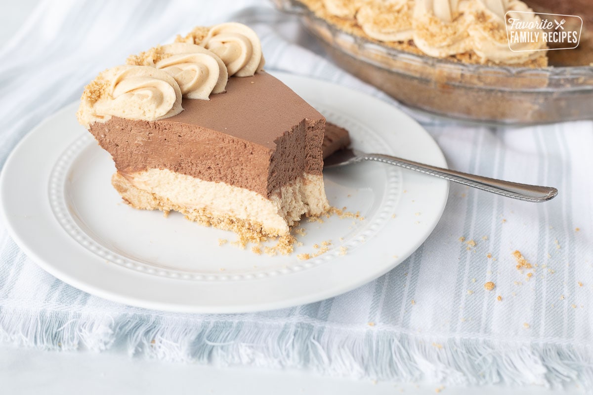 Side view of a slice of Costco Peanut Butter Chocolate Cream Pie with a fork.