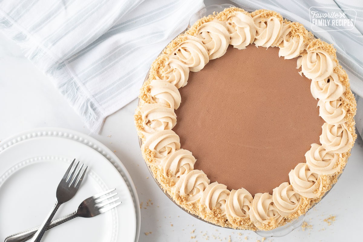 Costco Peanut Butter Chocolate Cream Pie with plates and two forks.