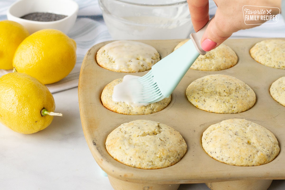 Brushing the glaze on top of the Lemon Poppy Seed Muffins.