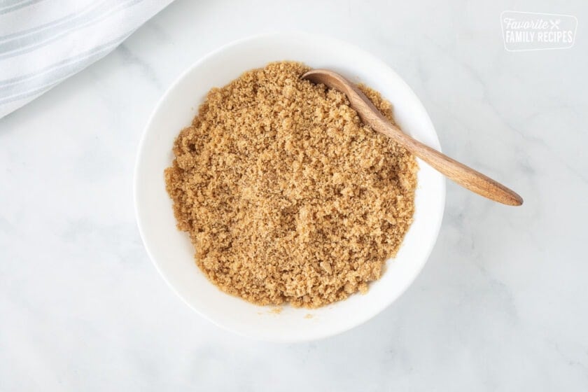 Bowl with graham cracker mixture for Costco Peanut Butter Chocolate Cream Pie.