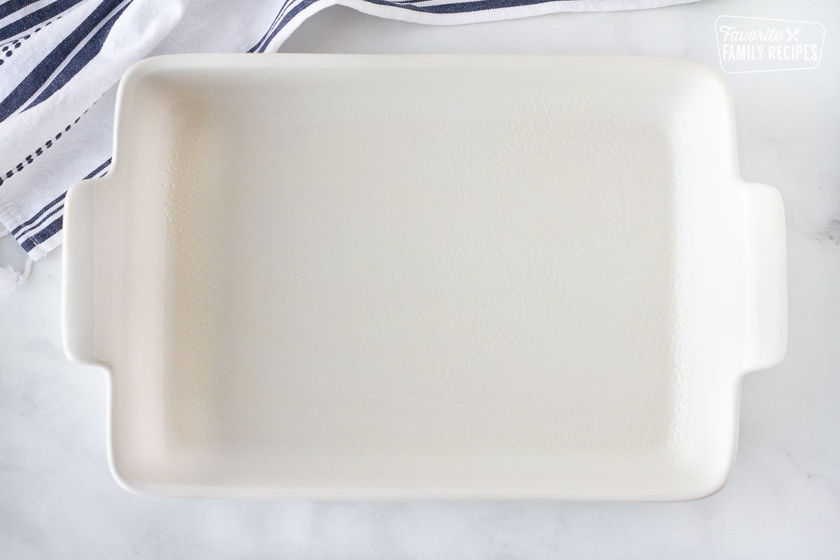 Baking dish greased with cooking spray for Sour Cream Chicken Enchiladas.