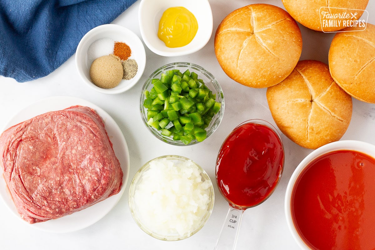 Ingredients to make Homemade Sloppy Joes including rolls, ground beef, onion, green bell peppers, ketchup, tomato soup, mustard, brown sugar and spices.