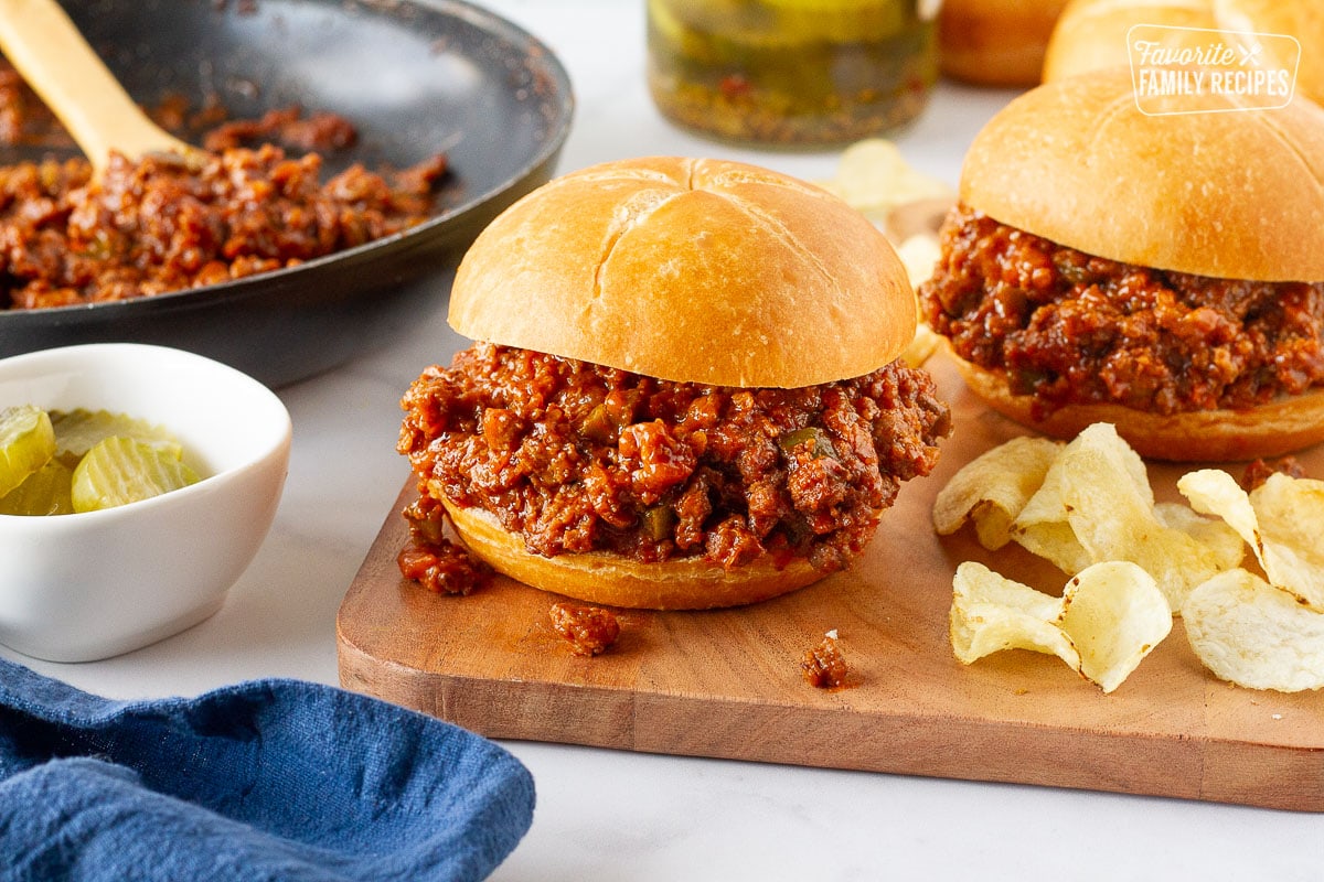 Two Homemade Sloppy Joes with potato chips.