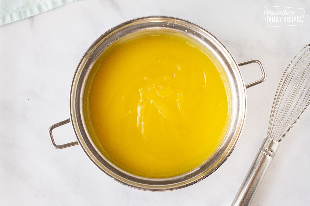 Egg yolks added to Lemon custard base in a sauce pan for Lemon Meringue Pie.