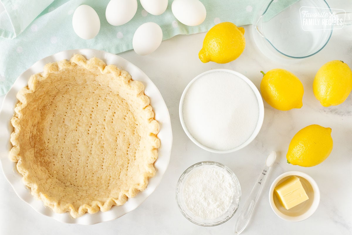 Ingredients for Lemon Meringue Pie including lemons, sugar, corn starch, butter, salt, eggs, water and pie crust.