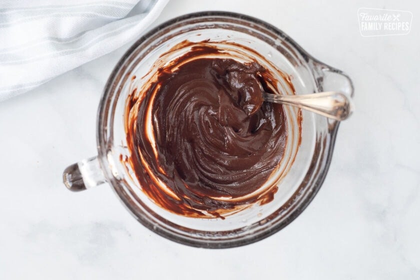 Mixing bowl of melted chocolate chips for Costco Peanut Butter Chocolate Cream Pie.