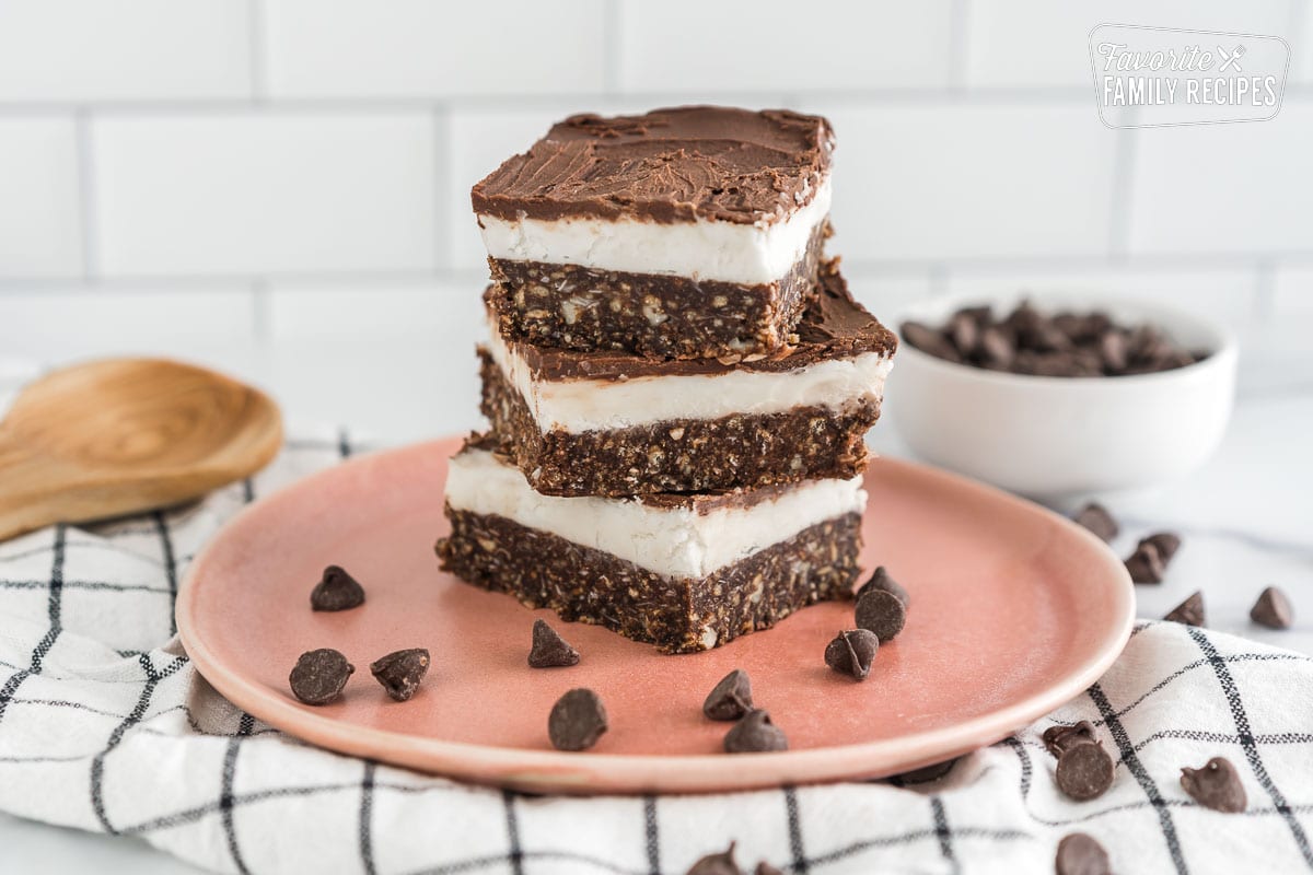 Three Nanaimo Bars stacked on a plate