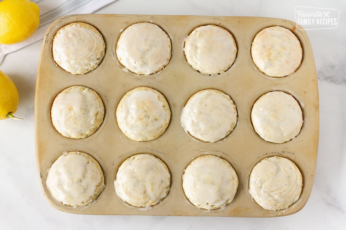 Glazed pan of twelve Lemon Poppy Seed Muffins.