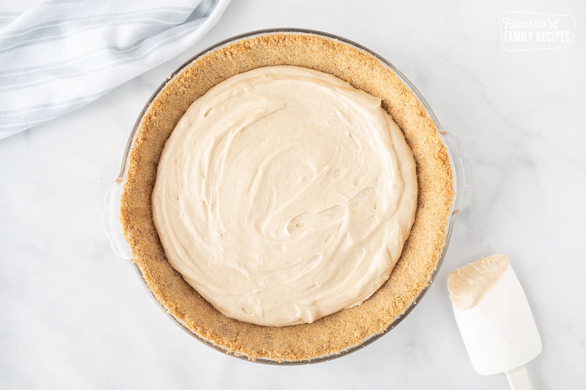 Graham cracker crust with a peanut butter layer for Costco Peanut Butter Chocolate Cream Pie.