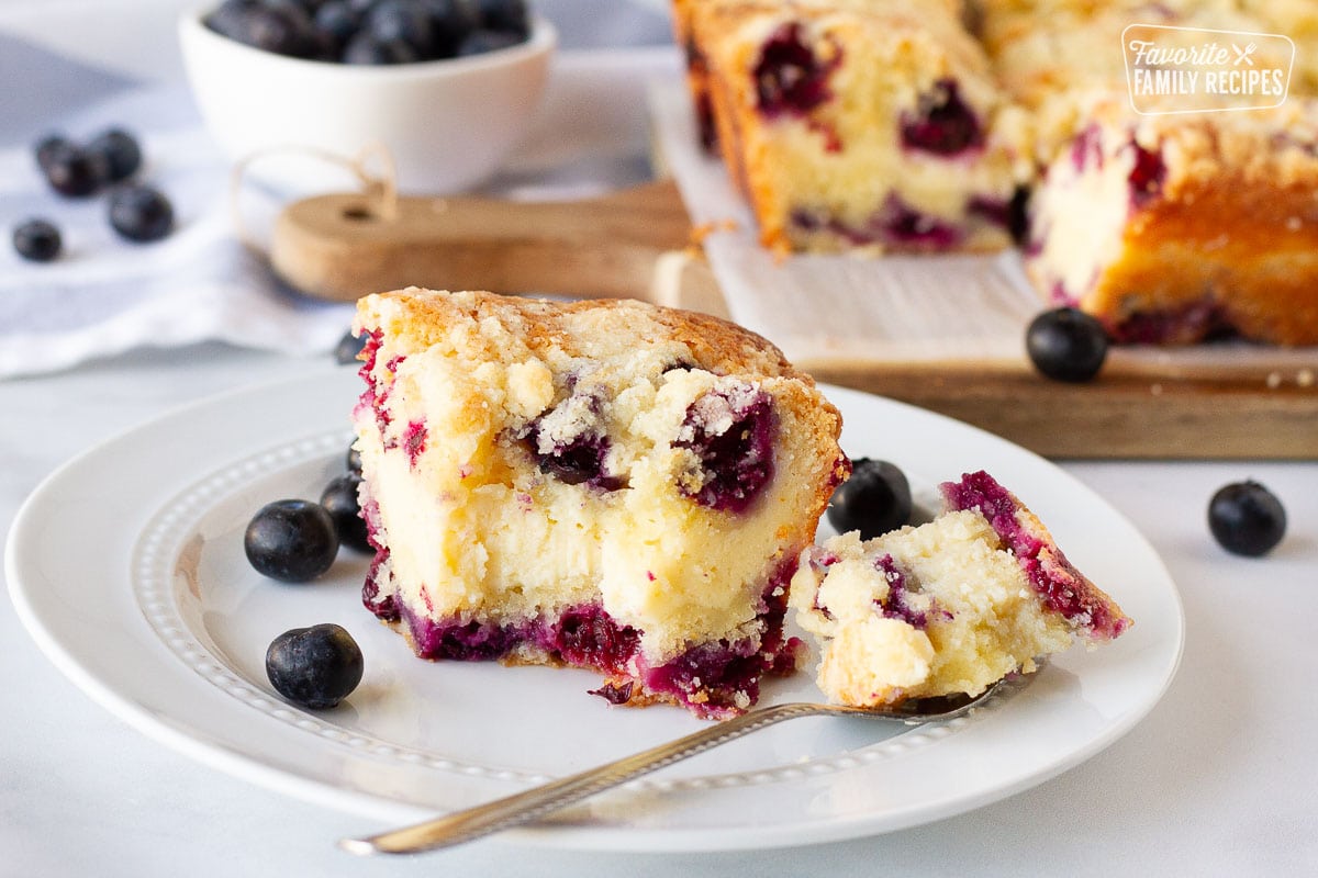Plate of Blueberry Coffee Cake with a fork holding a piece of the cake.