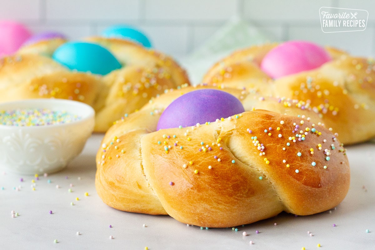 Side of an Easter Bread round loaf with a purple colored egg in the middle.