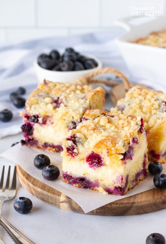 Three slices of Blueberry Coffee Cake. Fresh blueberries on the side.