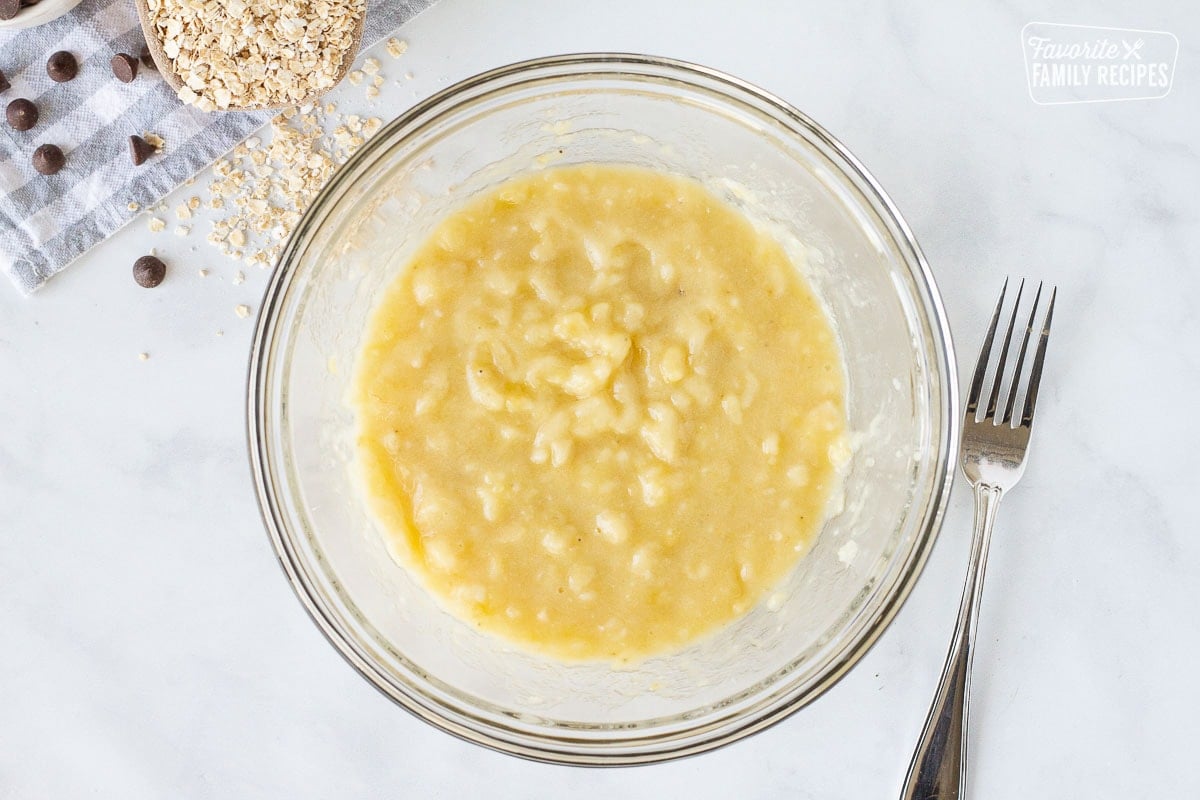 Bowl with mashed up bananas for Healthy Oatmeal Cookies.