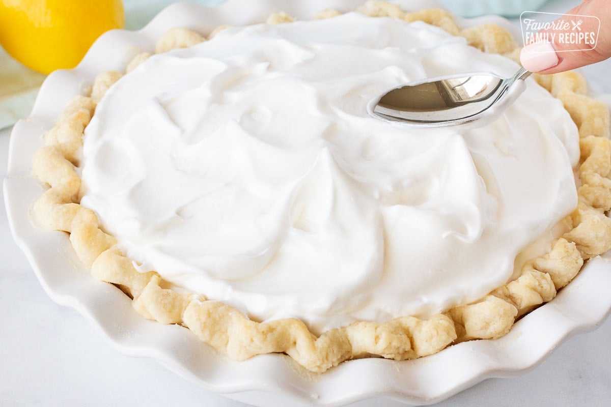 Spoon spreading and forming peaks with the soft Meringue for Lemon Meringue Pie.