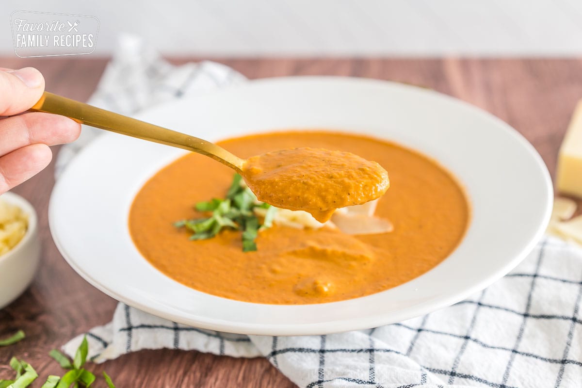 A spoonful of tomato basil soup.