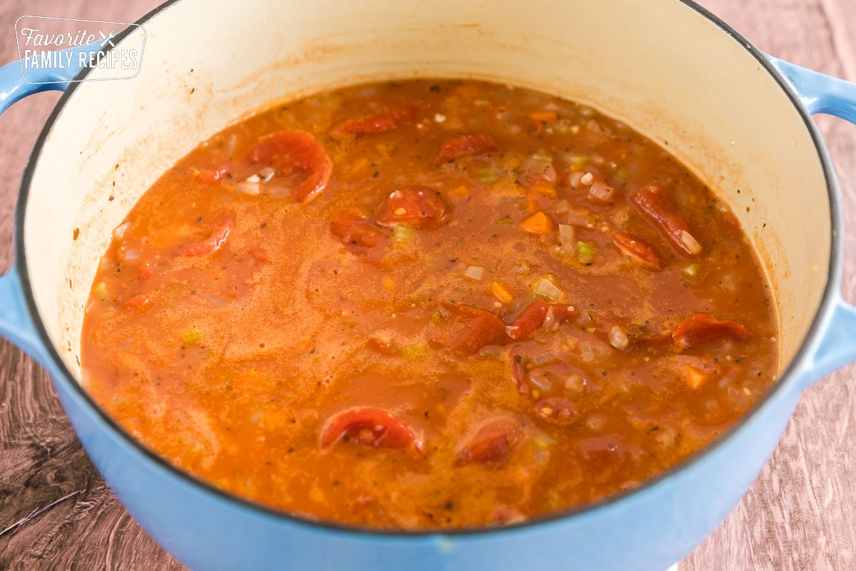 Ingredients for tomato basil soup in a dutch oven before being simmered.