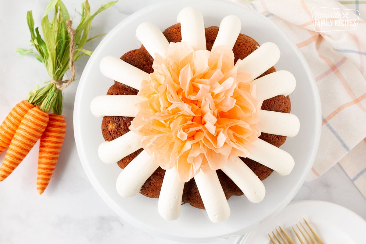 Cake Stand with Carrot Bundt Cake and a tissue Pom pom.