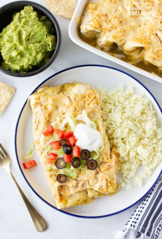 Plate of Sour Cream Chicken Enchiladas with a side of rice.