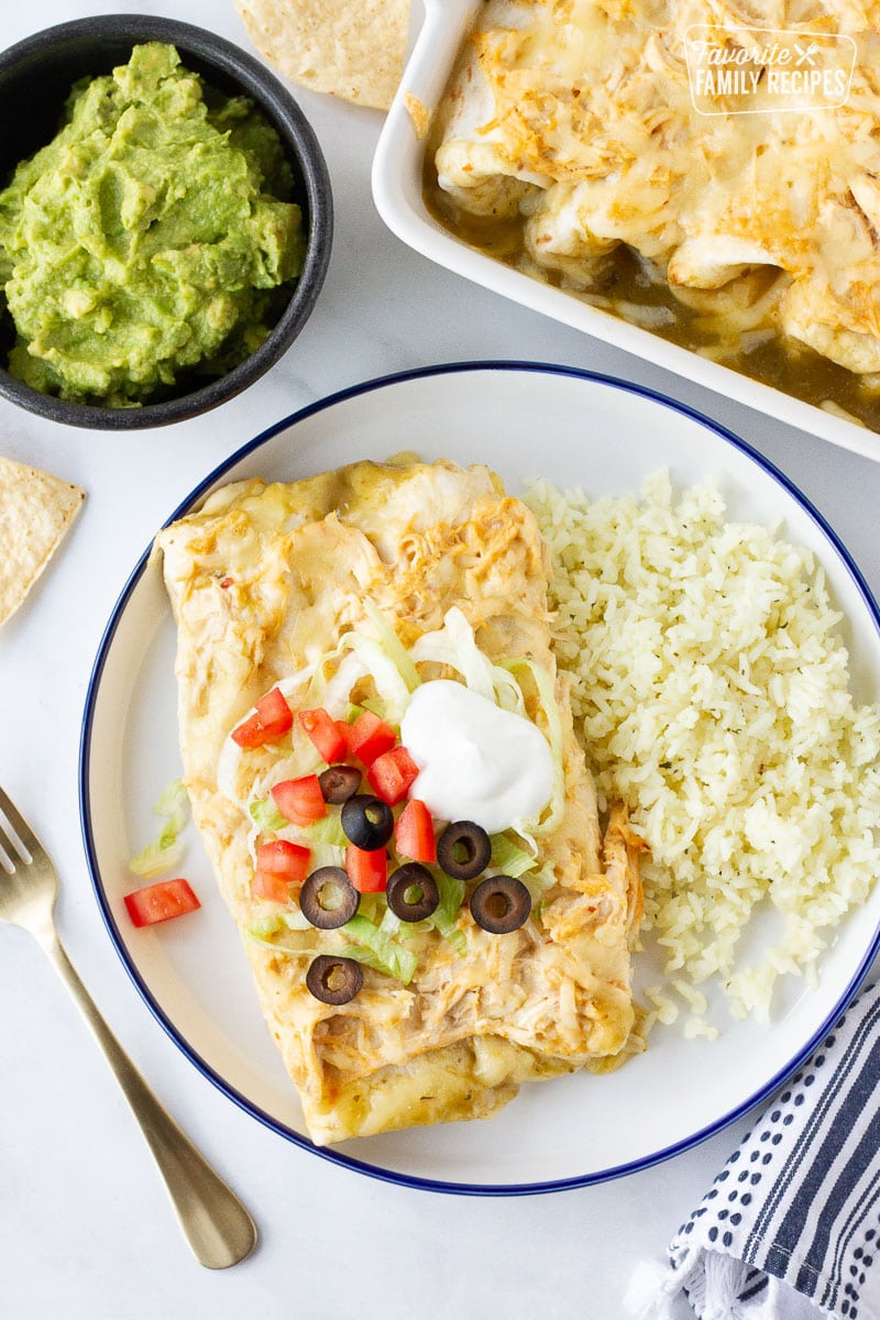 Plate of Sour Cream Chicken Enchiladas with a side of rice.