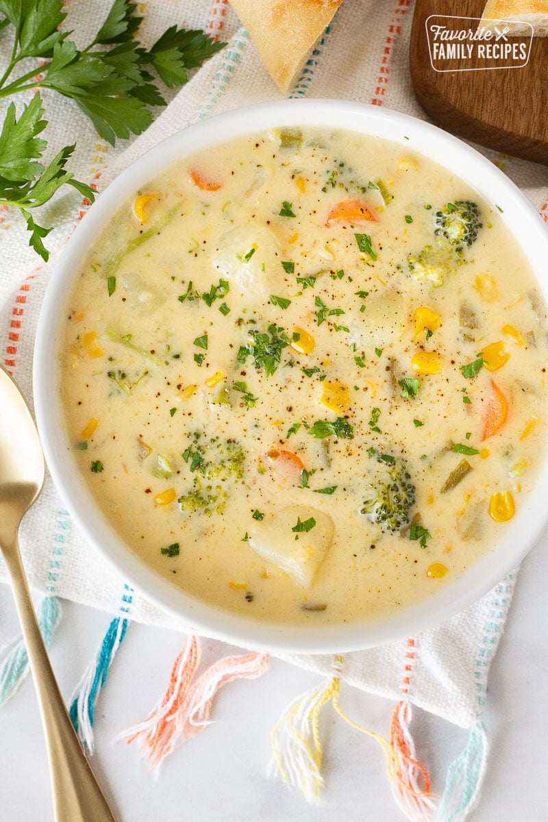 Close up bowl of Creamy Vegetable Soup with carrots, broccoli, corn, celery and potatoes.