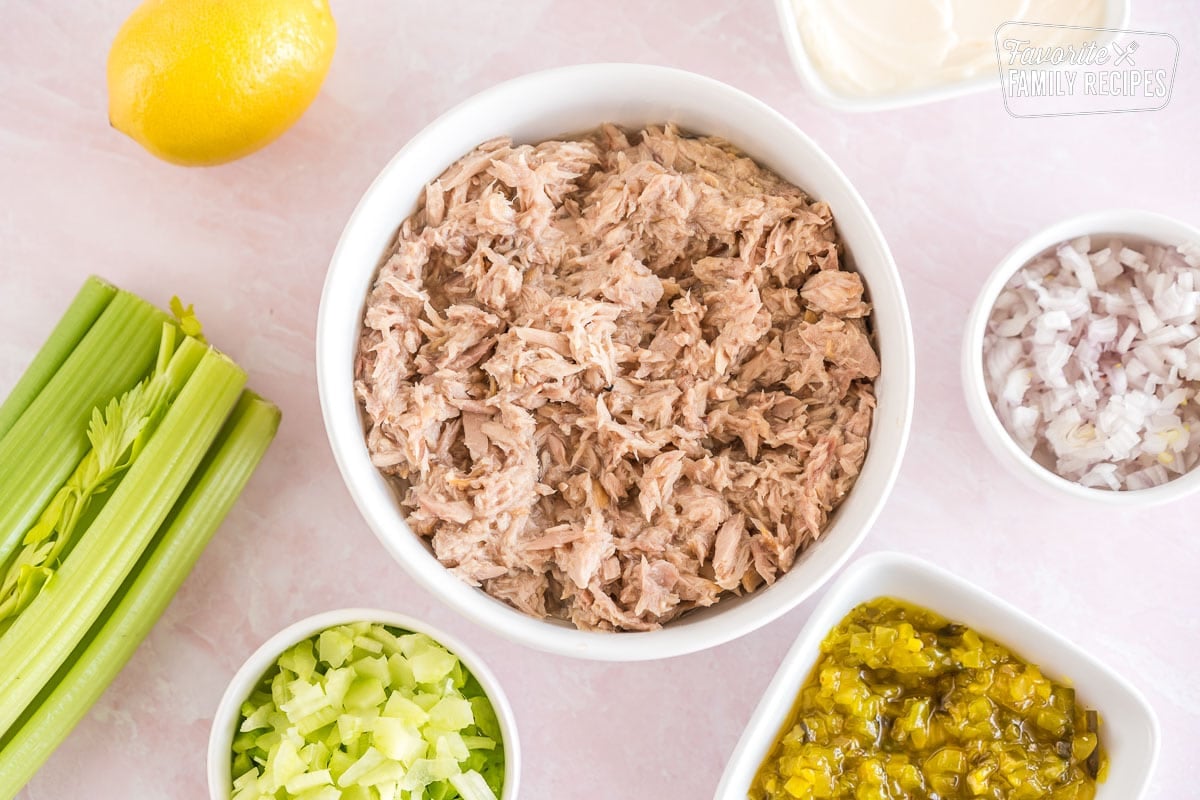 Tuna, celery, shallots, relish, lemons, and mayo all in small bowls 