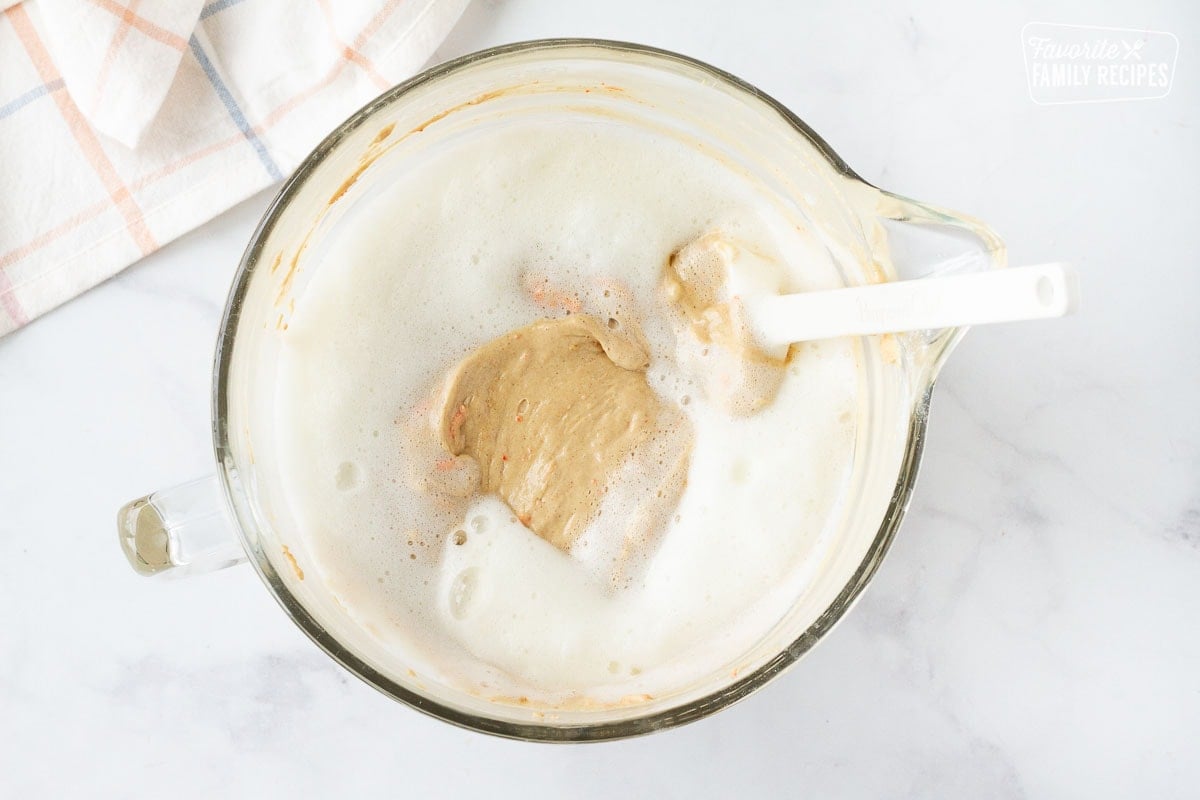 Mixing bowl with Carrot Bundt Cake batter folding with whipped egg whites.