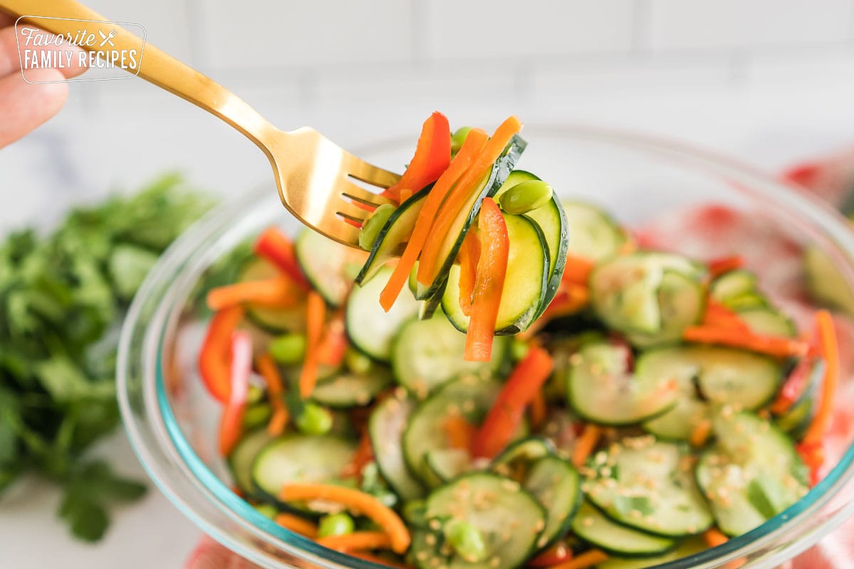 A bite of Asian cucumber salad on a fork