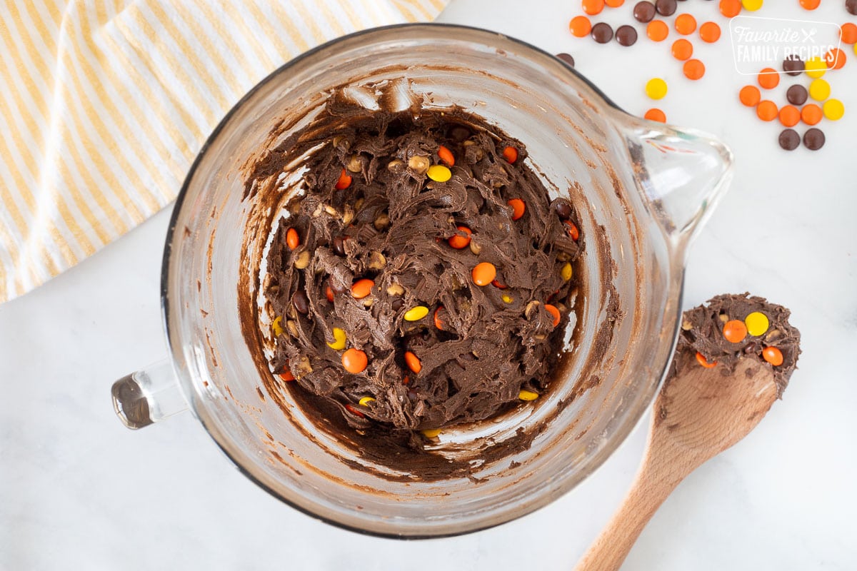 Mixing bowl of Reeses Pieces Cookies with candies mixed in.