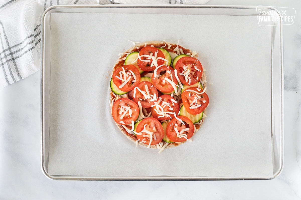 Baking sheet with remaining mozzarella cheese added on Healthy Pizza.
