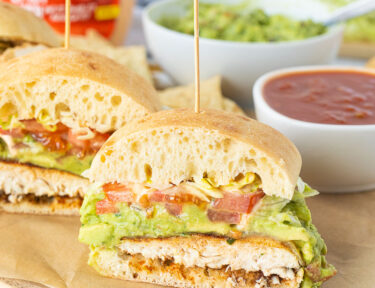 Chicken Torta cut in half with a toothpick on top.