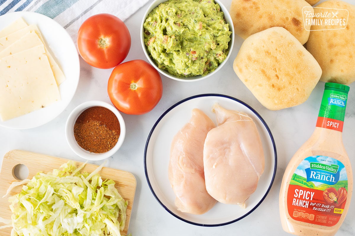 Ingredients to make Chicken Tortas including chicken breasts, torta bread, guacamole, pepper jack cheese, lettuce, tomatoes, seasonings and spicy ranch.