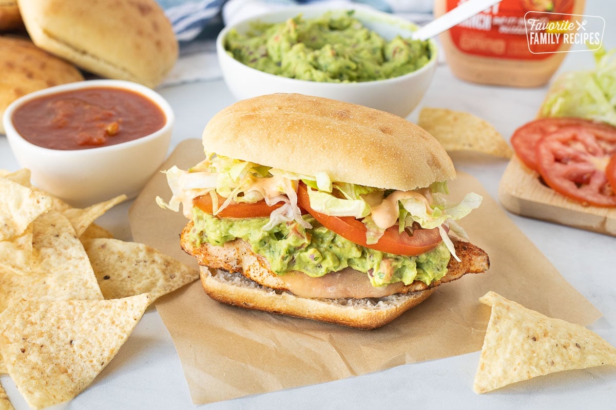 Chicken Torta sandwich with tortilla chips and salsa.