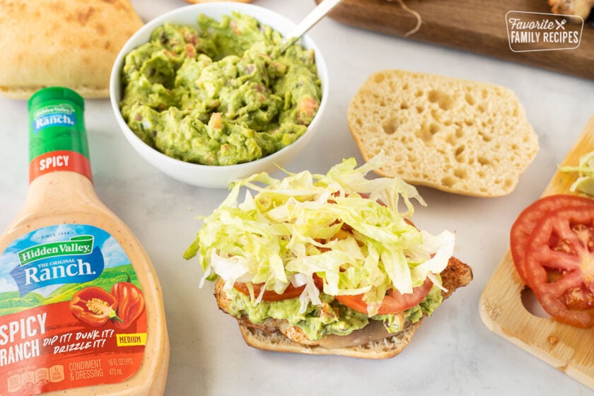 Tomato an lettuce on top of Chicken Torta sandwich.