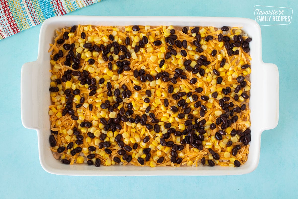 Baking dish with black beans and corn for Mexican Chicken Casserole.