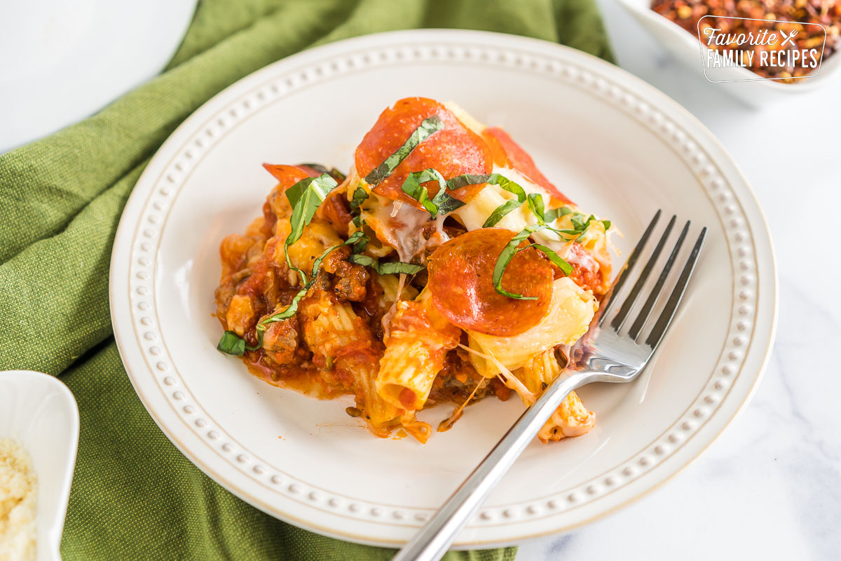 A plate with a scoop of crockpot pizza casserole on it