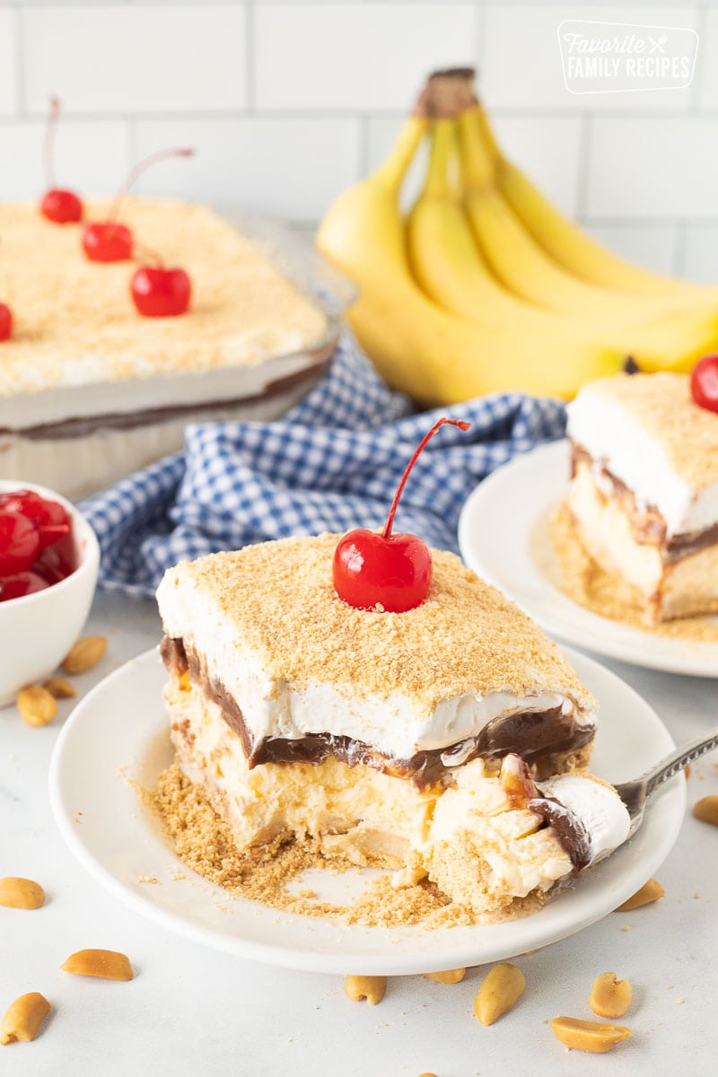 Fork next to Banana Split Dessert on a plate.