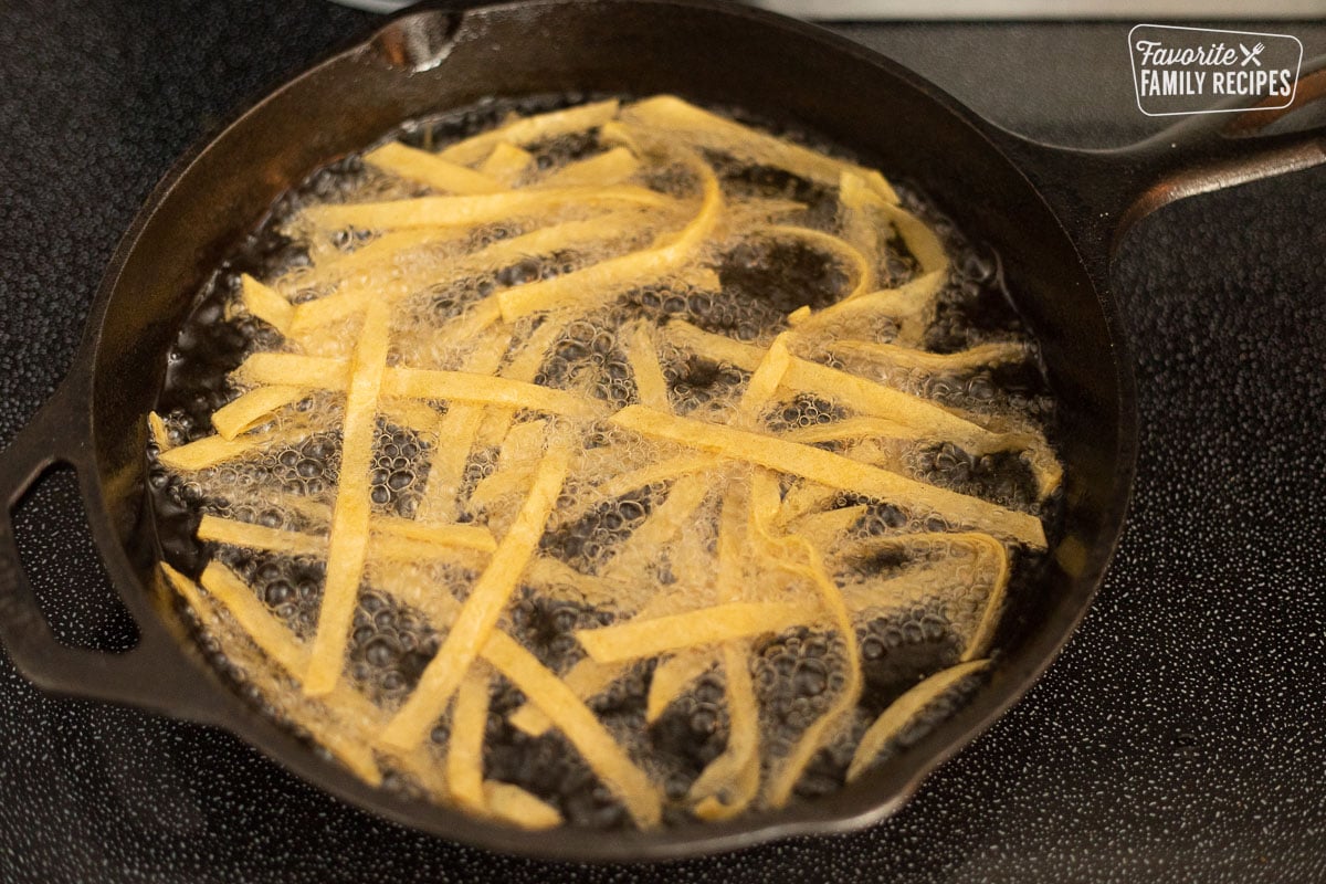 Frying Tortilla Strips in a pan with oil.