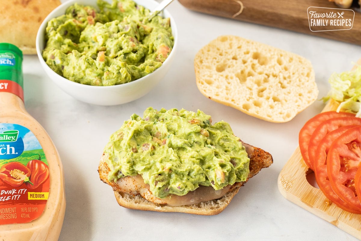 Guacamole on top of a chicken breast for Chicken Tortas.