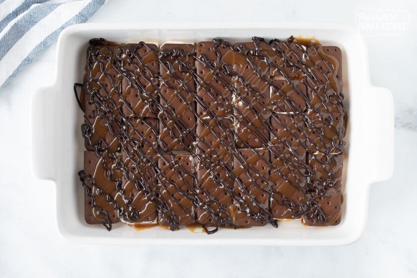 Rectangle dish with hot fudge and caramel sauce for Ice Cream Sandwich Cake.