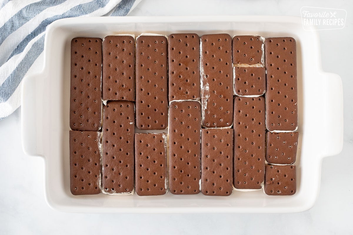 Rectangular dish with a layer of Ice Cream Sandwiches cut to fit for cake.