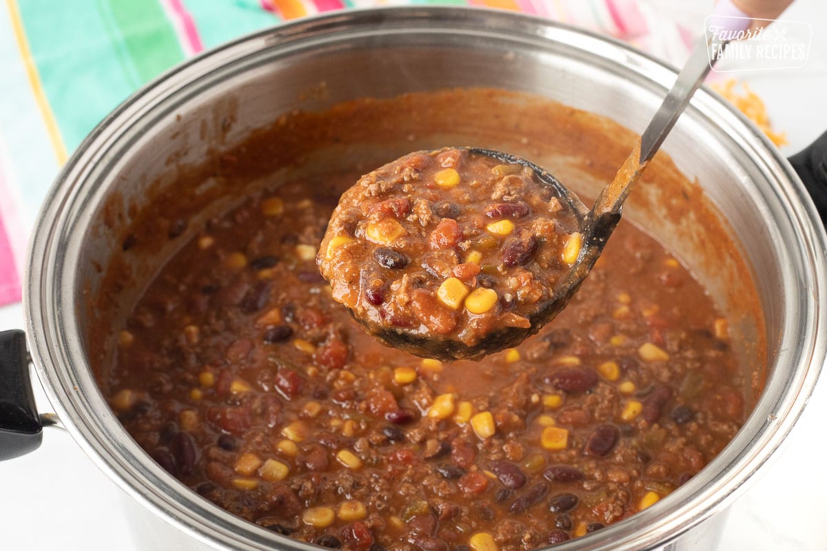 Ladle holding a scoop of Mexican Chili over the pot of chili.