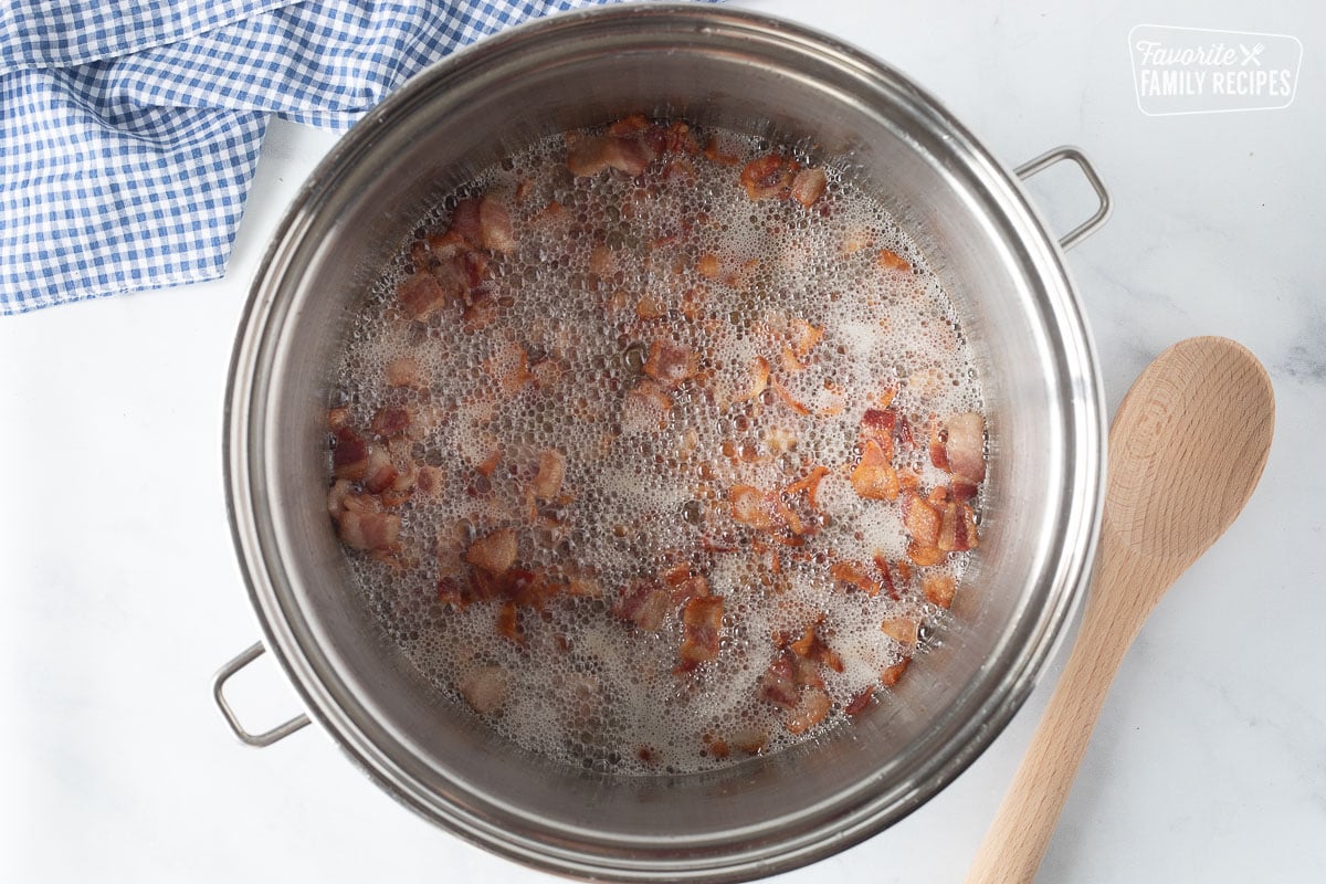 Bacon cooking in a pot for Loaded Potato Soup.