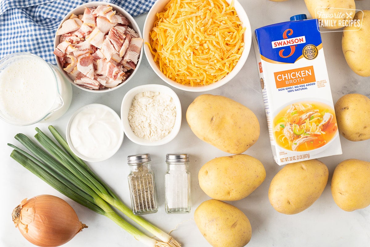 Ingredients to make Loaded Potato Soup including chicken broth, cheese, bacon, flour, half and half, sour cream, potatoes, onions, salt, pepper and green onions.
